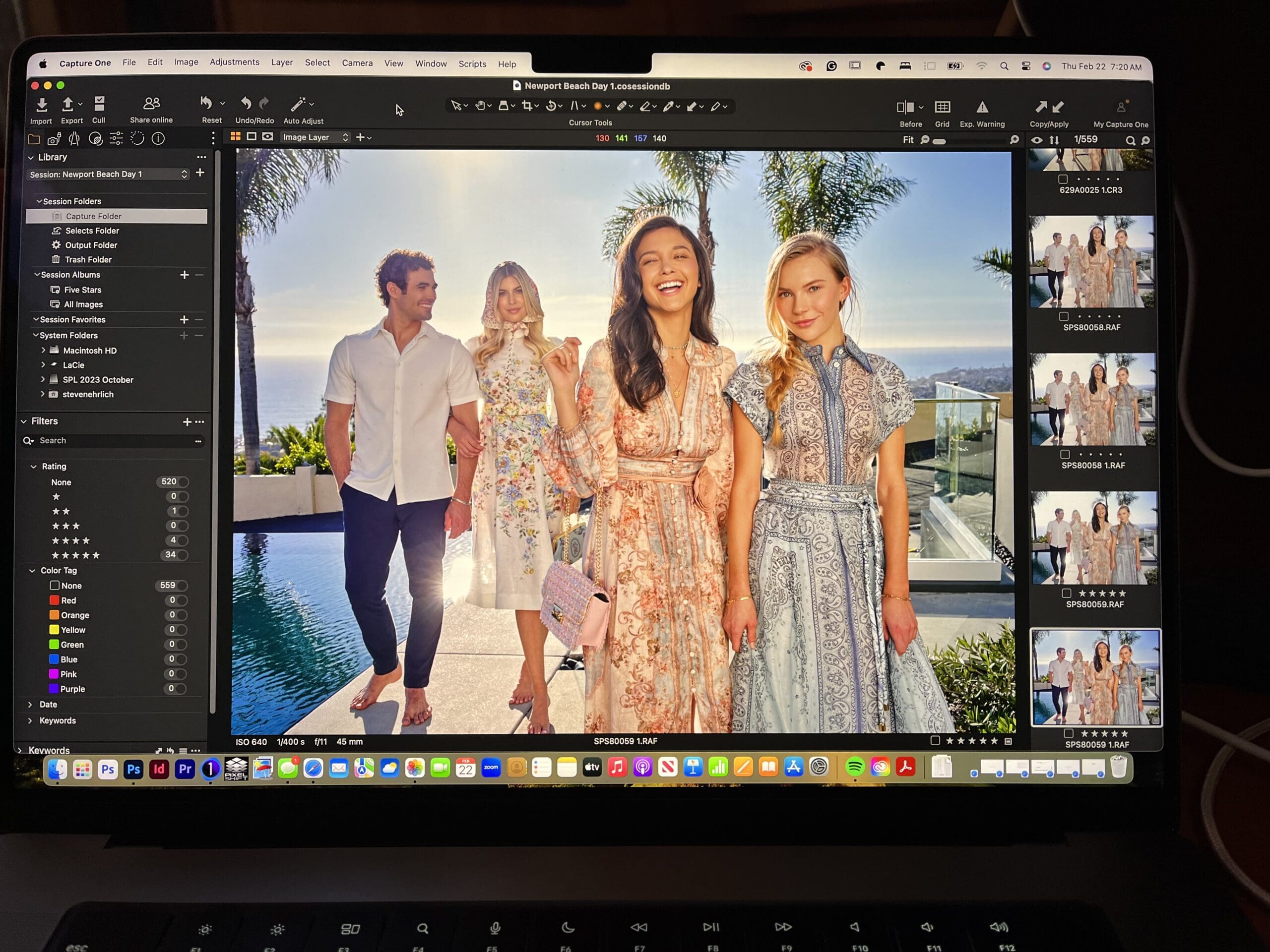 Laptop screen showing Capture One editing software with a lifestyle photo of four models in patterned dresses walking beside a pool